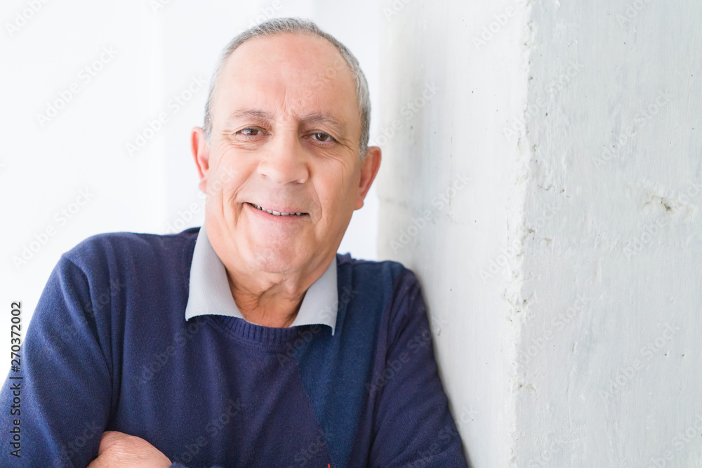 Handsome middle age senior man smiling cheerful, happy and positive leaning over white background with crossed arms Handsome middle age senior man smiling cheerful, happy and positive leaning over white background with crossed arms