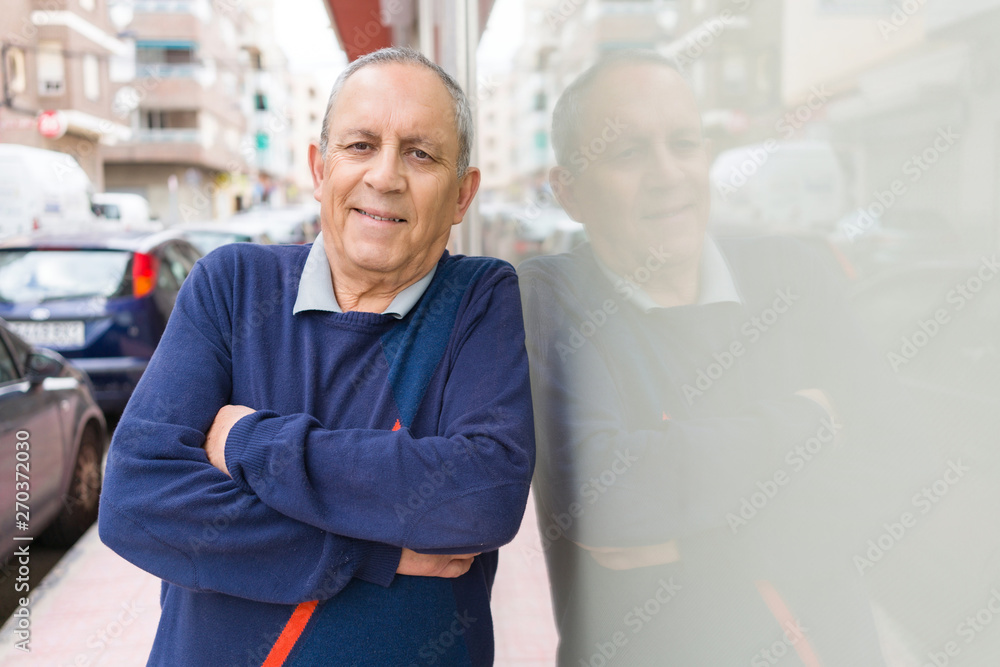 Handsome middle age senior man smiling cheerful, happy and positive with crossed arms leaning on the wall Handsome middle age senior man smiling cheerful, happy and positive with crossed arms leaning on the wall