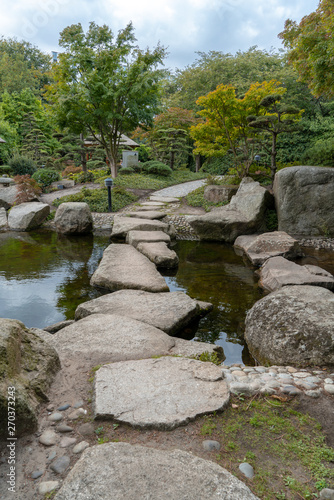 stone path through water in the japanese garden in hamburgs park