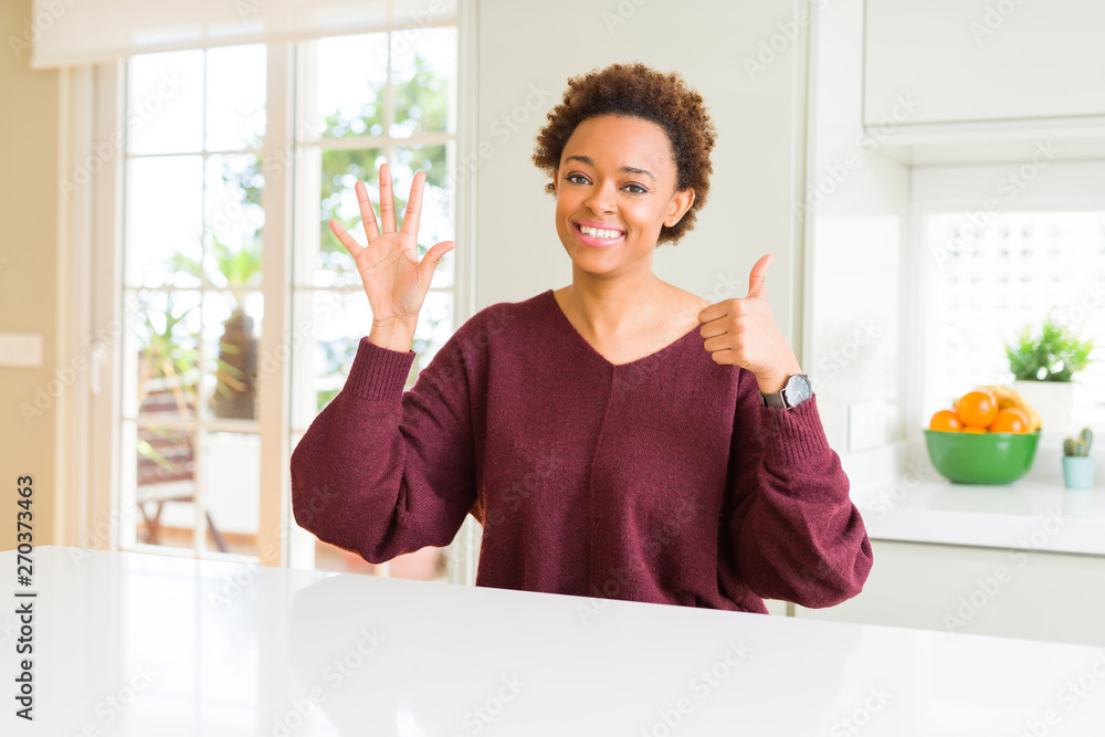 Young beautiful african american woman at home showing and pointing up with fingers number six while smiling confident and happy. Young beautiful african american woman at home showing and pointing up with fingers number six while smiling confident and happy.