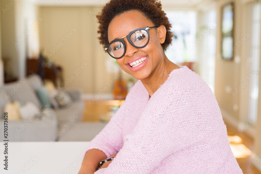 Beautiful young african woman with afro hair wearing glasses