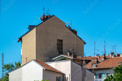 Television antennas on roofs of houses.