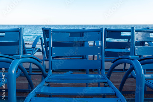 Blue chairs on the English embankment in Nice.