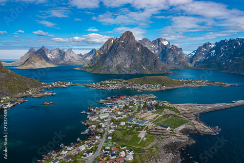 Aerial view of Reine, Lofoten islands, Norway. The fishing village of Reine. Spring time in Nordland. Blue sky. View from above.