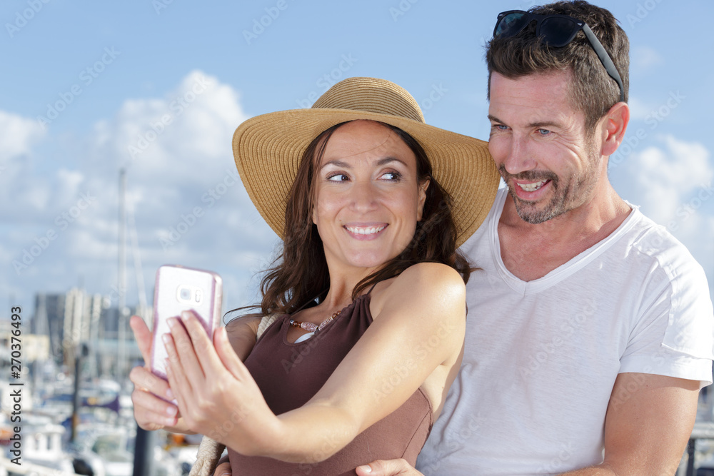 portrait of middle-aged couple taking selfie with a smartphone