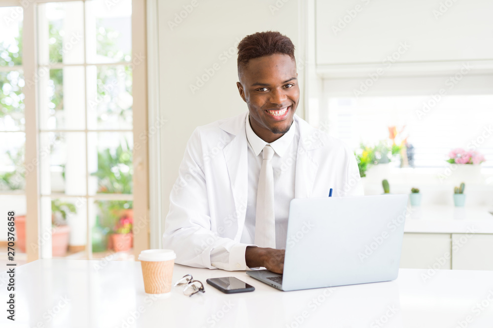 Handsome african proffesional man working using laptop for the business smiling cheerful Handsome african proffesional man working using laptop for the business smiling cheerful