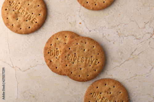 Stack of sweetmeal digestive biscuits closeup of a pile of biscuits on a texture background photo