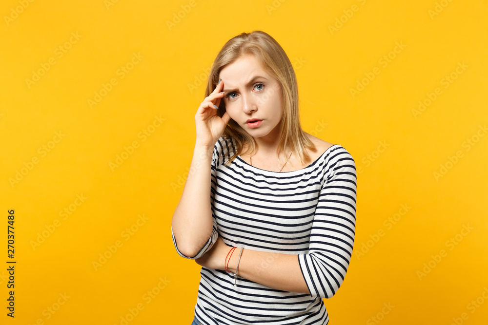 Perplexed puzzled young woman in striped clothes looking camera putting hand on head isolated on yellow orange wall background in studio. People sincere emotions lifestyle concept. Mock up copy space. Perplexed puzzled young woman in striped clothes looking camera putting hand on head isolated on yellow orange wall background in studio. People sincere emotions lifestyle concept. Mock up copy space.