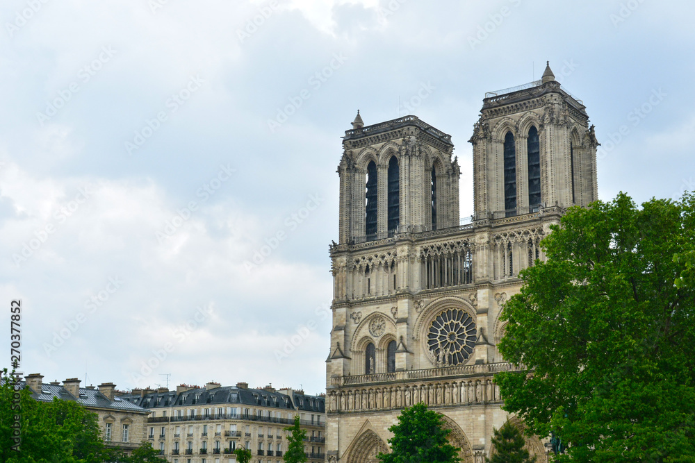 Legendary Paris cathedral Notre Dame. Beautiful Parisian achitecture. Magnificent landmark after destructive fire. Paris, France