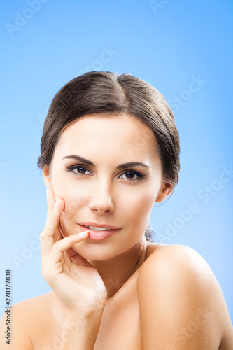 Portrait of young beautiful woman, on blue color background