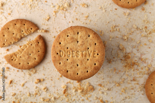 Stack of sweetmeal digestive biscuits closeup of a pile of biscuits on a texture background photo