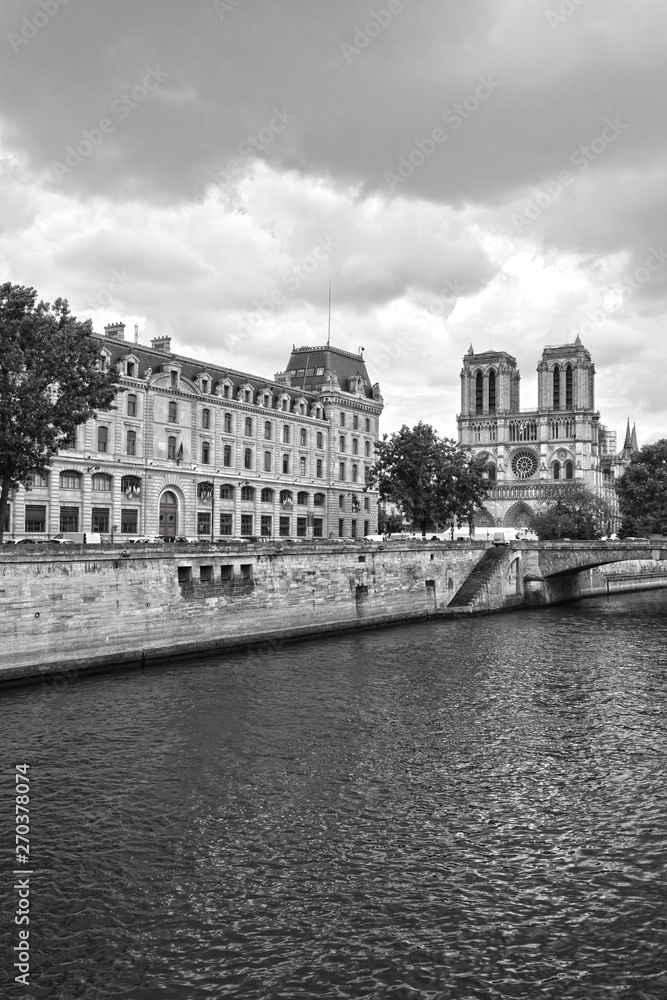 Legendary Paris cathedral Notre Dame. Beautiful Parisian achitecture. Magnificent landmark after destructive fire.Panorama of Seine river with gothic cathedral in view.Paris, France