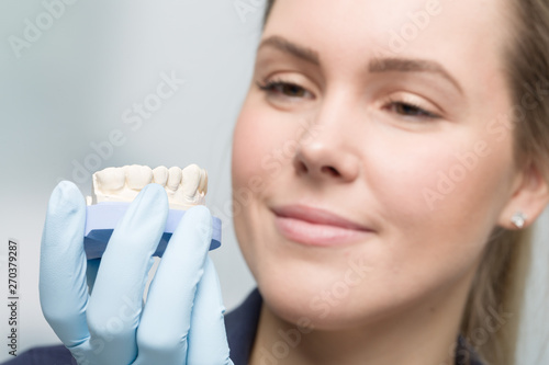 close up of female dental technician working on artificial dention