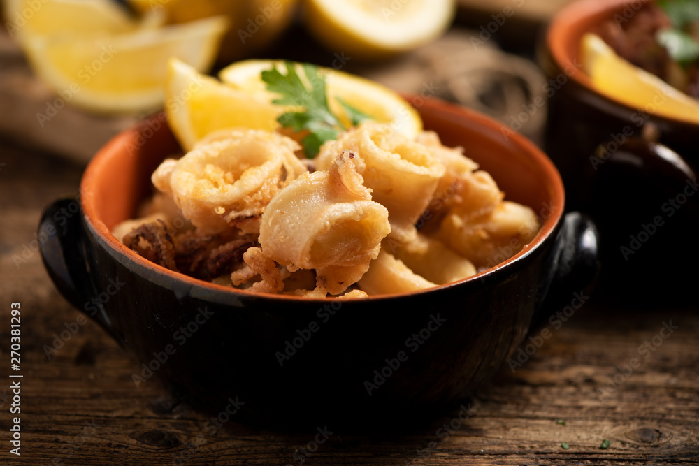Traditional Italian fried calamari and lemon slice Traditional Italian fried calamari and lemon slice