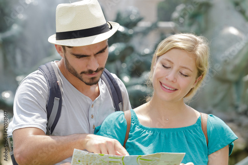 young tourist couple with map outdoors