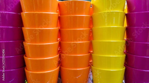 Stacks of colorful ceramic flower pots.