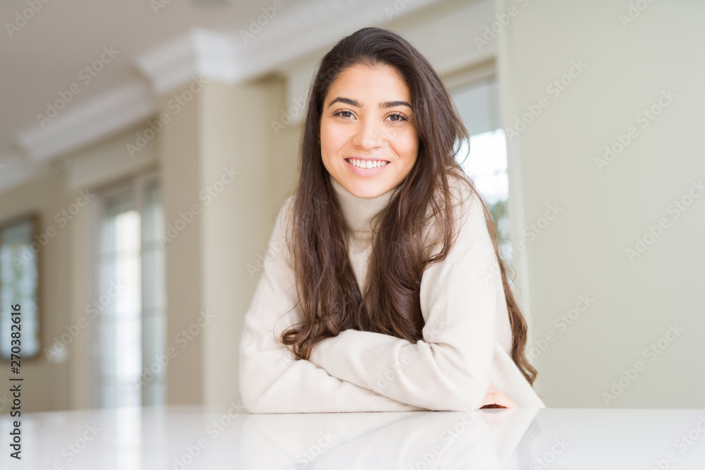 Beautiful brunette woman smiling cheerful with big smile, looking positive and happy with crossed arms Beautiful brunette woman smiling cheerful with big smile, looking positive and happy with crossed arms