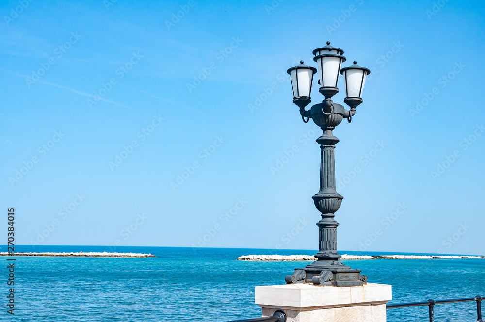 Historical lamp by the sea in town.