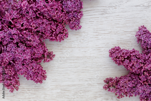 Background of lilac flowers on a wooden surface