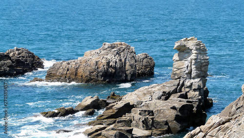 One white rock in the Ocean of Brittany Quiberon with the blue of water surrounding. It s on the wild coast of a peninsula island. © Wijiji