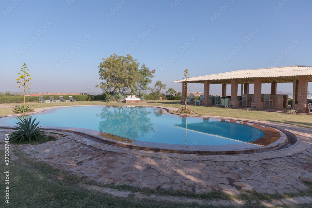 Pool and clubhouse with no people at Reggie's camel camp in Osian Jodhpur Rajasthan India