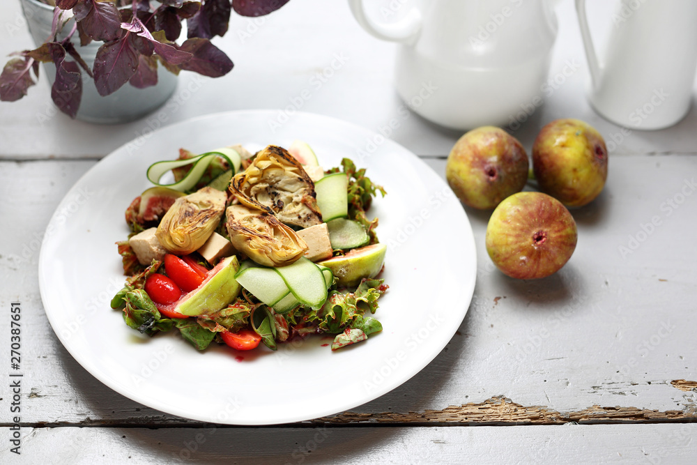 A light vegetarian salad with fig, artichoke, cucumber, tomatoes, feta on ruccola leaves, topped with raspberry sauce. A light vegetarian salad with fig, artichoke, cucumber, tomatoes, feta on ruccola leaves, topped with raspberry sauce.