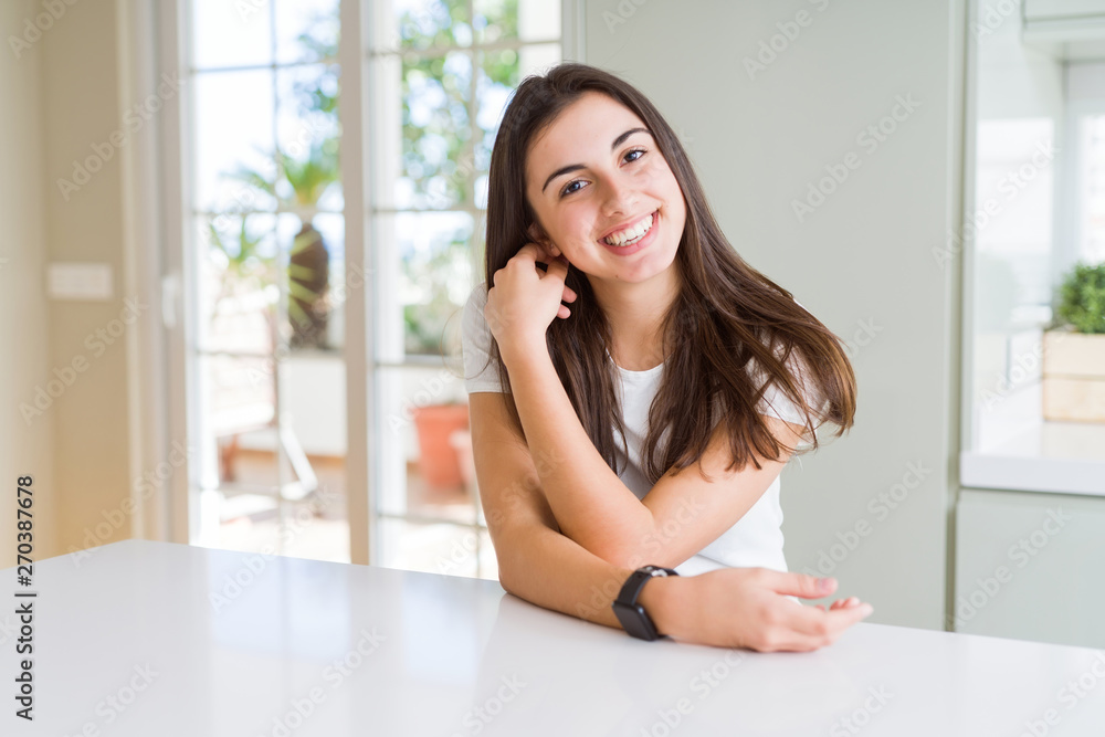 Beautiful young brunette woman smiling cheerful looking at the camera with a big smile on face showing teeth Beautiful young brunette woman smiling cheerful looking at the camera with a big smile on face showing teeth