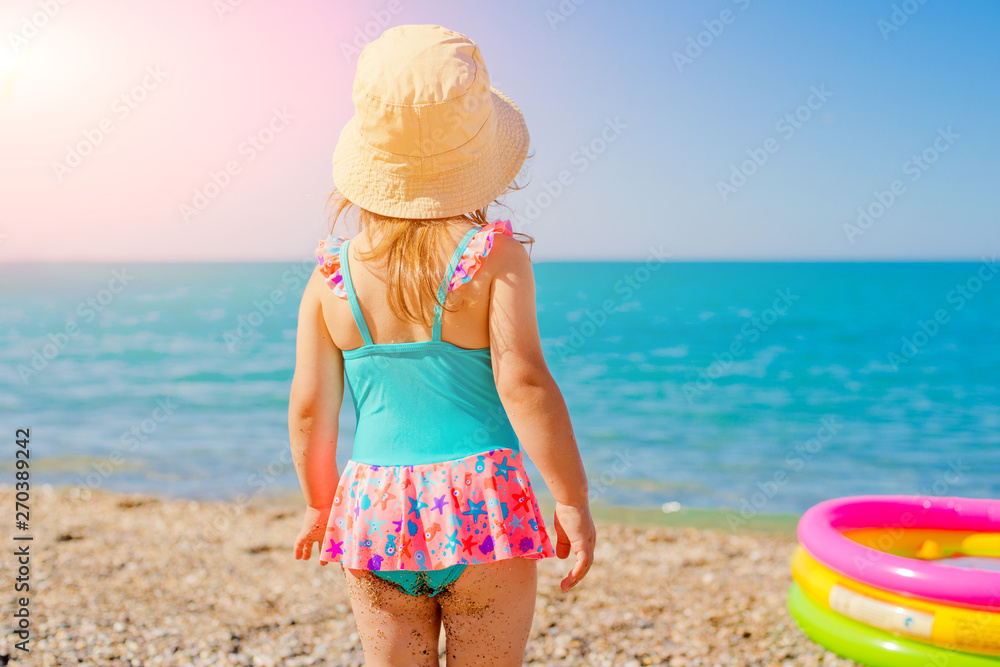 little girl in swimsuit looking at the sea Stock Photo Adobe Stock