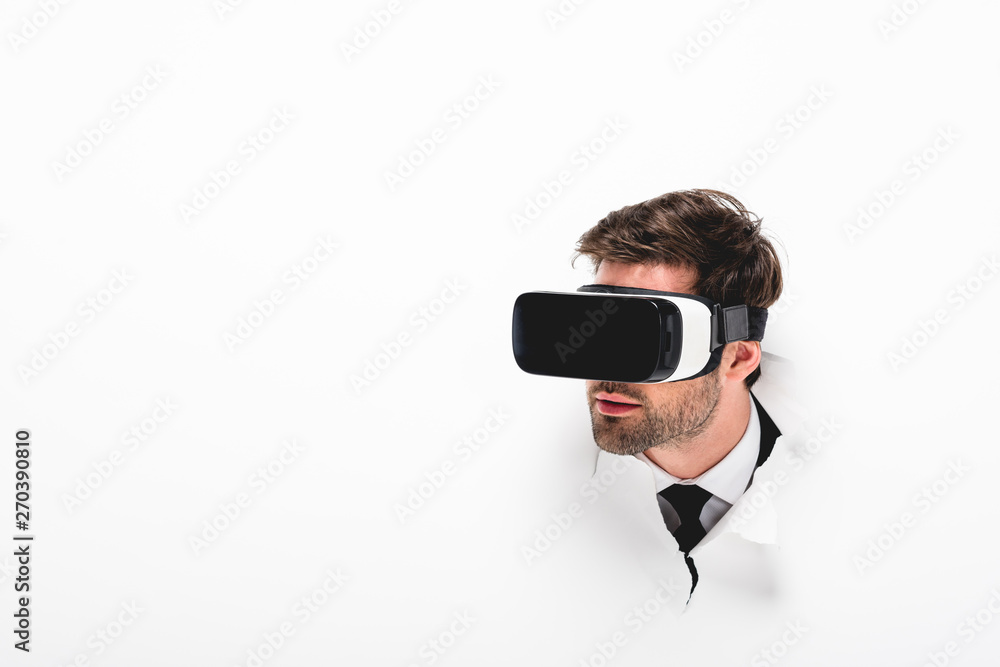 man in Virtual reality headset behind hole in wall on white with copy space man in Virtual reality headset behind hole in wall on white with copy space