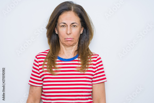 Middle age senior woman standing over white isolated background depressed and worry for distress, crying angry and afraid. Sad expression.