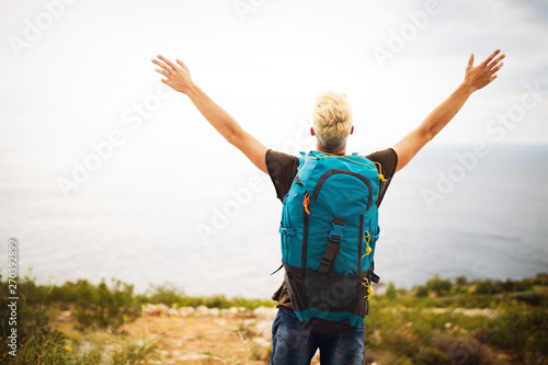 Traveler man with backpack landscape on background. Travel, happy, summer, vacations concept.