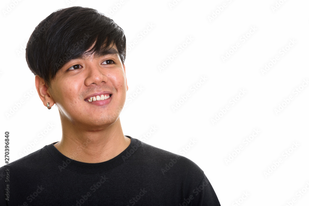 Studio shot of cool happy Asian man smiling and thinking Studio shot of cool happy Asian man smiling and thinking