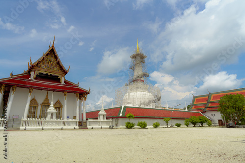 Wat Phra Mahathat Woramahawihan, buddhist temple in Nakorn Sri Thammarat province and the blue sky full of clouds in the beautiful day in the process of restoration