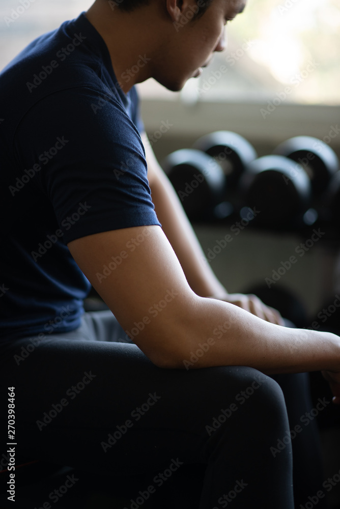 Young muscular lifting weights at gym Young muscular lifting weights at gym