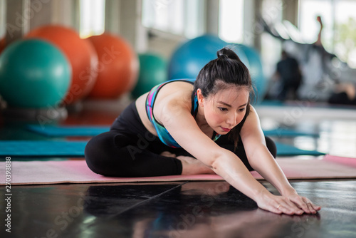 Attractive woman doing yoga exercise at the gym.