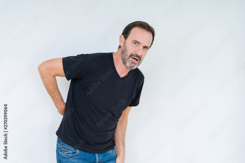 Senior man over isolated background Suffering of backache, touching back with hand, muscular pain Senior man over isolated background Suffering of backache, touching back with hand, muscular pain