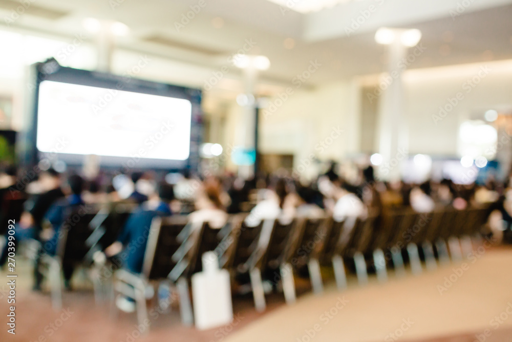 Fototapeta premium Blurry of auditorium for shareholders' meeting or seminar event with projector and white screen