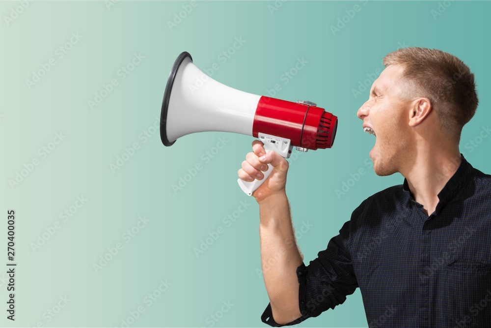 Portrait of woman holding megaphone, dressed in