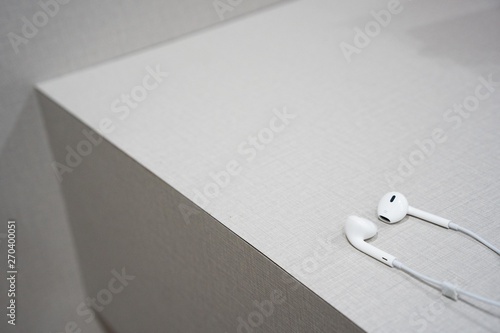 white earphone on the wooden table