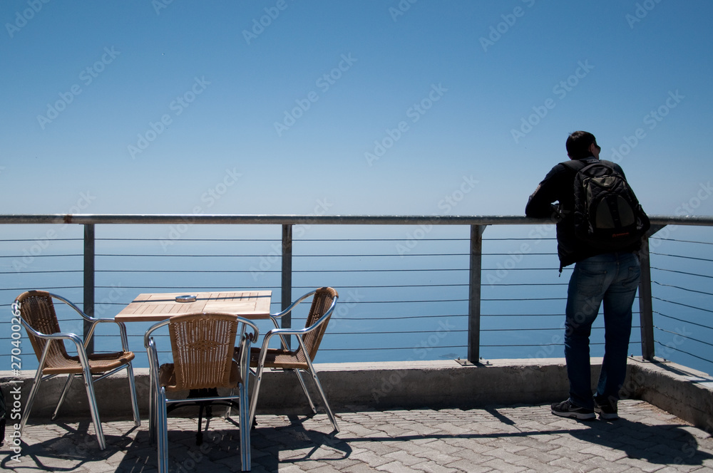 man in a cafe at the top of the mountain