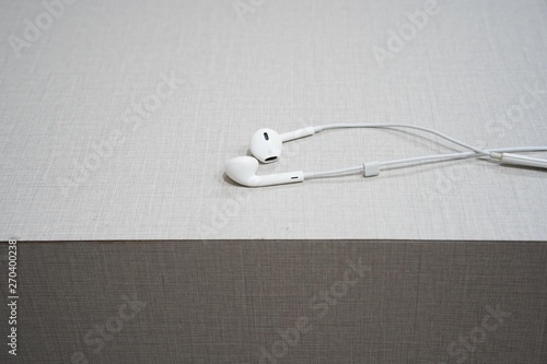 white earphone on the wooden table