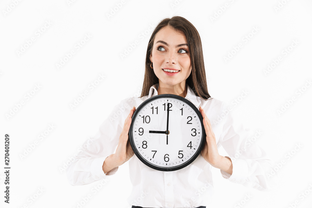 Photo of pretty female worker businesswoman dressed in formal wear holding big wall clock while working in office Photo of pretty female worker businesswoman dressed in formal wear holding big wall clock while working in office