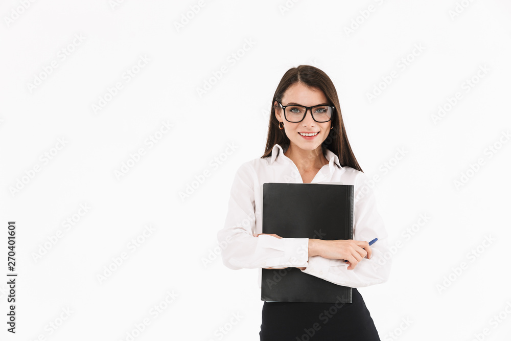 Photo of joyous female worker businesswoman dressed in formal wear holding bookbinder with documents while working in office Photo of joyous female worker businesswoman dressed in formal wear holding bookbinder with documents while working in office