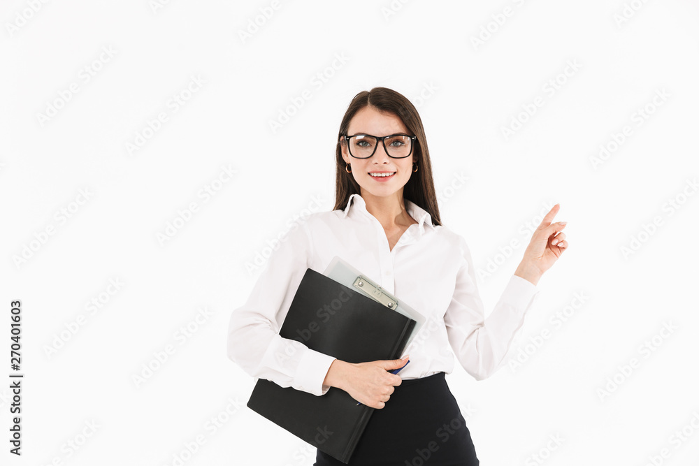Photo of charming female worker businesswoman dressed in formal wear holding bookbinder with documents while working in office Photo of charming female worker businesswoman dressed in formal wear holding bookbinder with documents while working in office