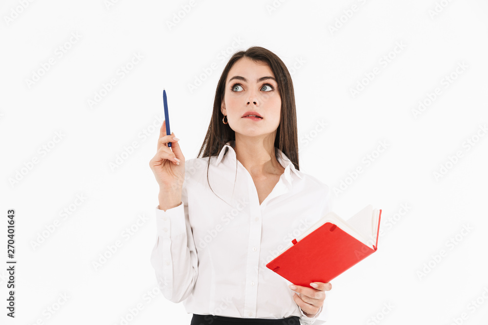 Photo of pleased female worker businesswoman dressed in formal wear holding day planner while working in office Photo of pleased female worker businesswoman dressed in formal wear holding day planner while working in office