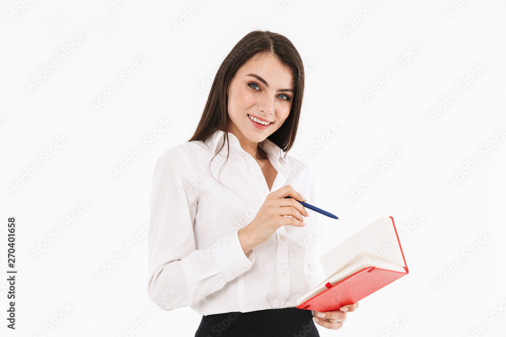 Photo of pretty female worker businesswoman dressed in formal wear holding day planner while working in office Photo of pretty female worker businesswoman dressed in formal wear holding day planner while working in office