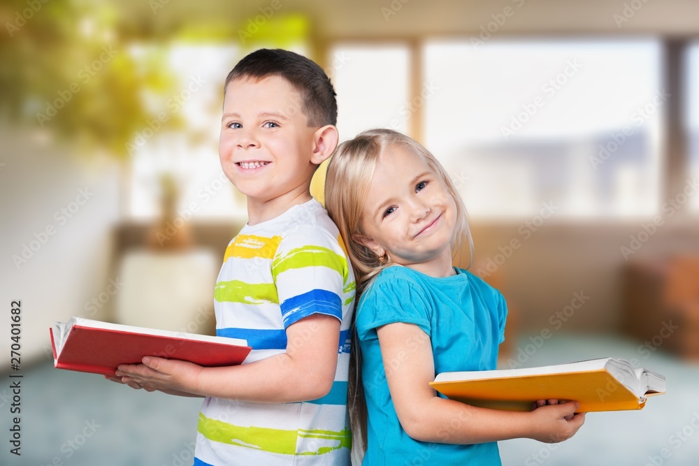 Cute boy and his little sister with books Cute boy and his little sister with books