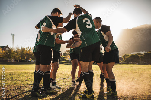 Rugby players cheering together after the game