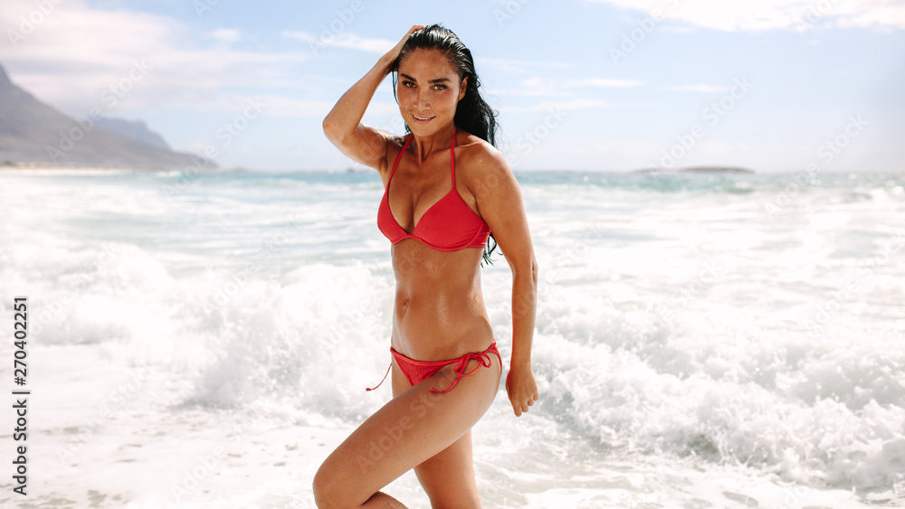 Beautiful woman posing in swimsuit on beach Beautiful woman posing in swimsuit on beach
