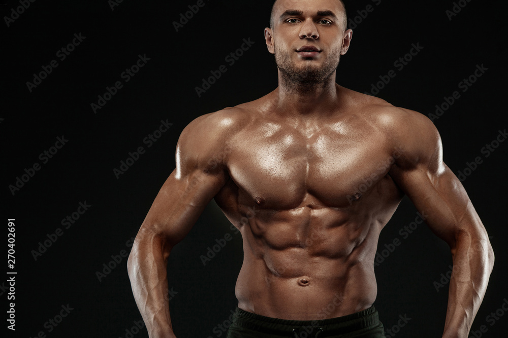 Fototapeta premium Bodybuilding competitions on the scene. Man sportsmen bodybuilder physique and athlete. Fitness motivation.